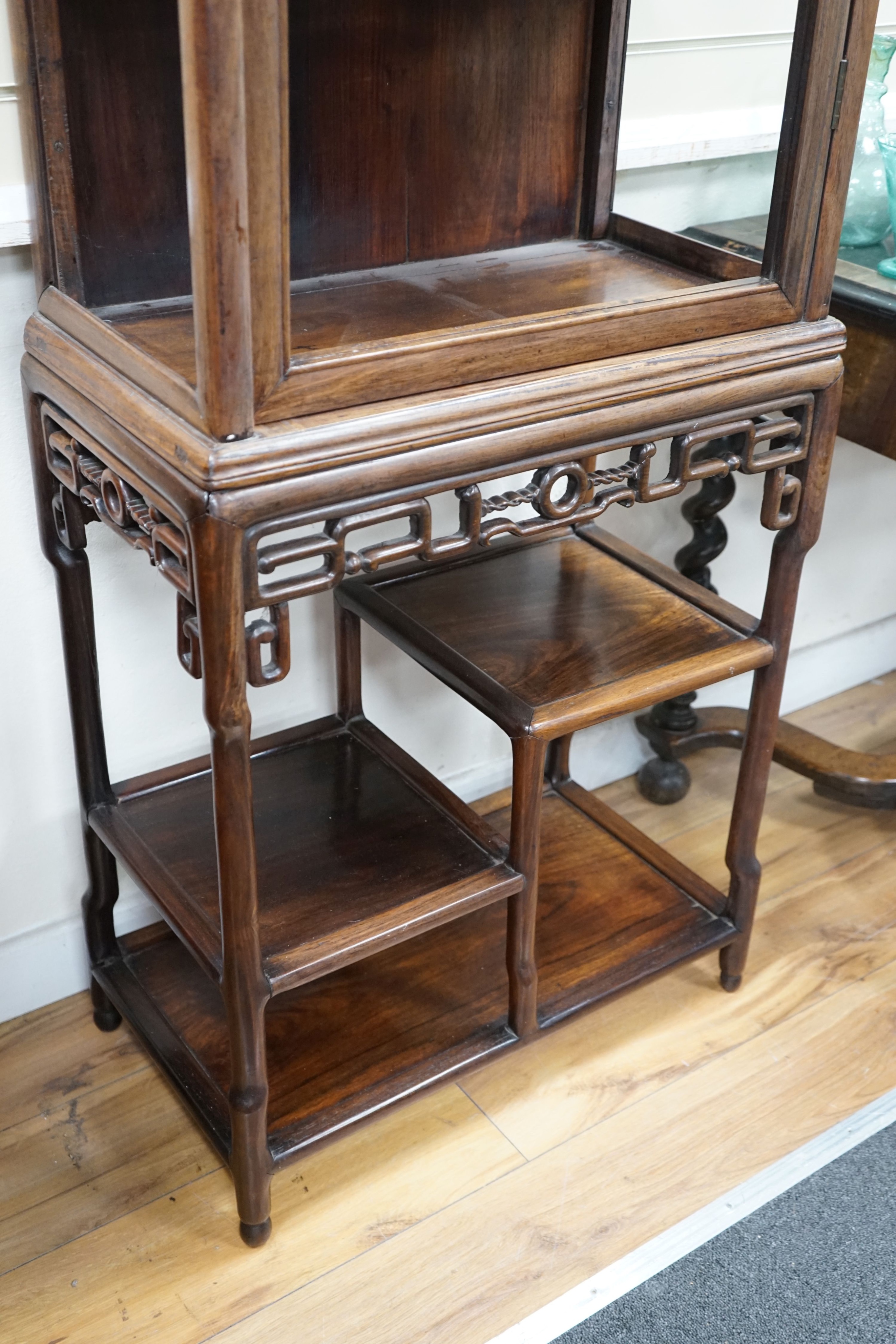 A Chinese hongmu cabinet on stand , circa 1900, lacking glazing, width 63cm, depth 35cm, height 185cm